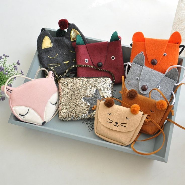 several small purses are sitting on a tray