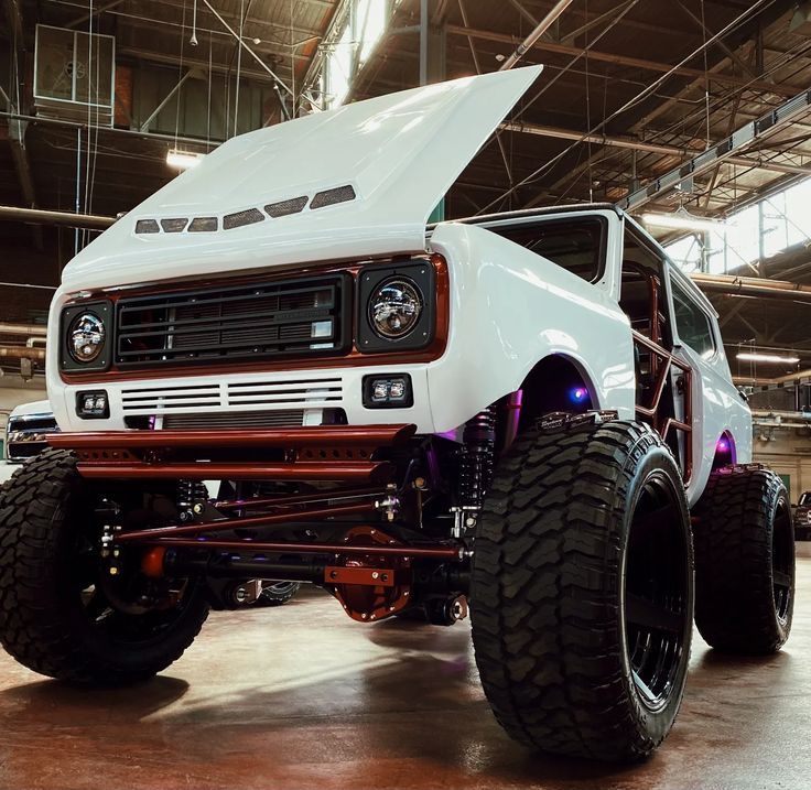 an off - road truck is parked in a warehouse