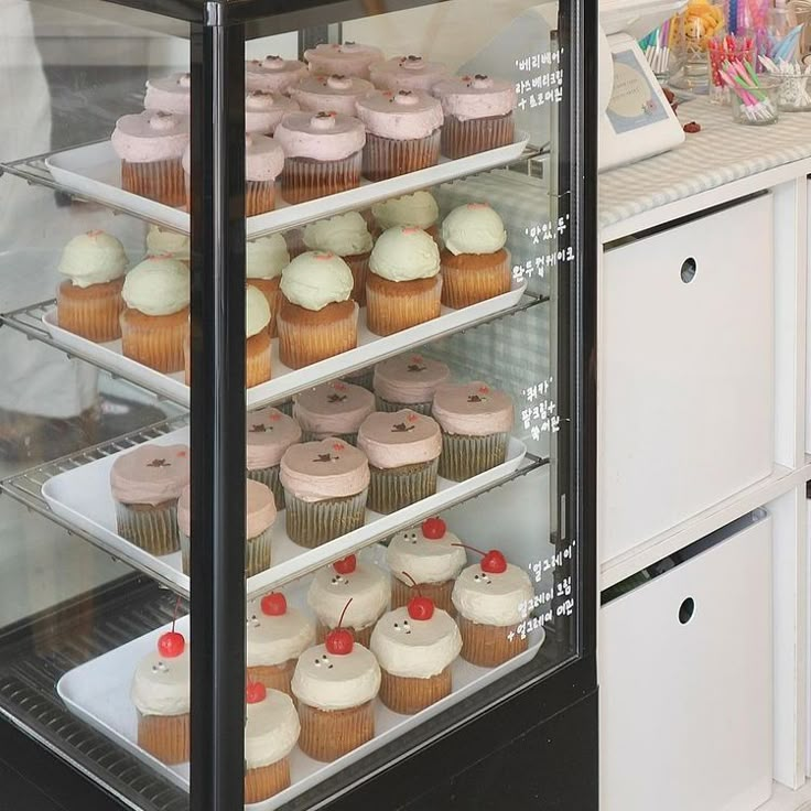 a display case filled with lots of cupcakes