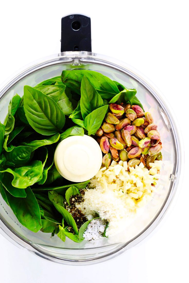 spinach, rice and other ingredients in a blender for making pesto salad