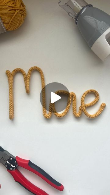 the word me spelled out with scissors and yarn next to it on a white surface