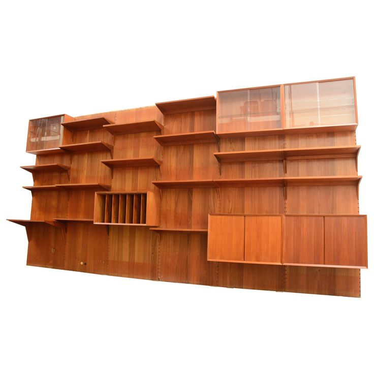 a large wooden shelf with many shelves on it's sides and one section open