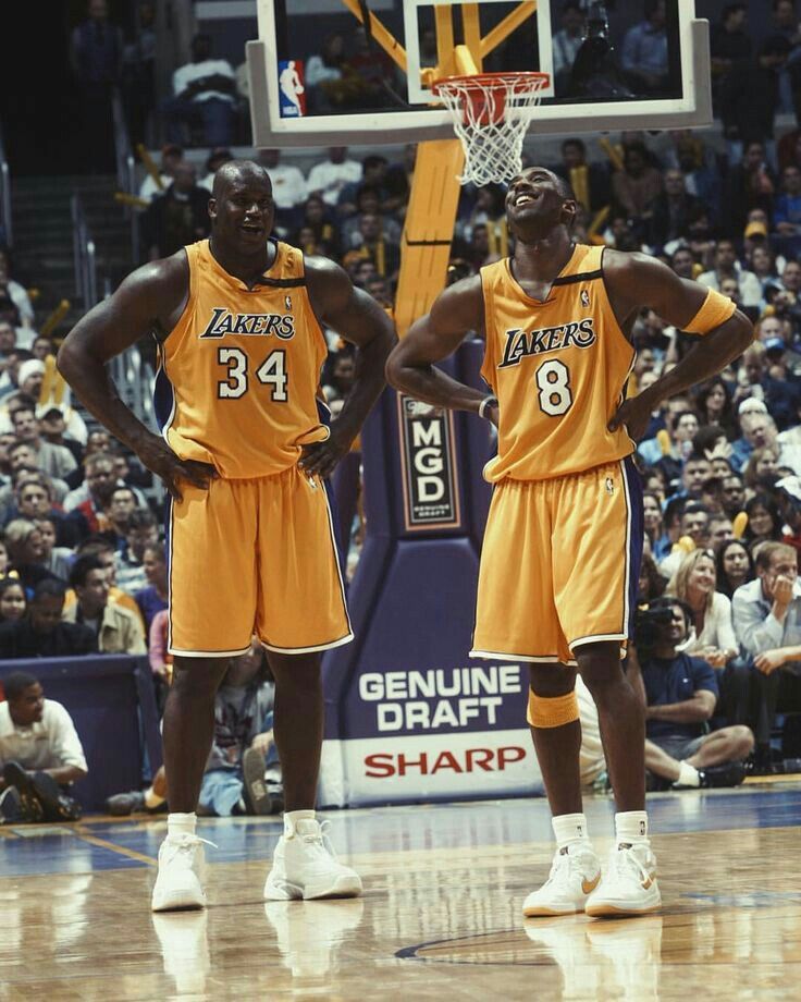 two basketball players are standing in front of the net with their hands on their hipss