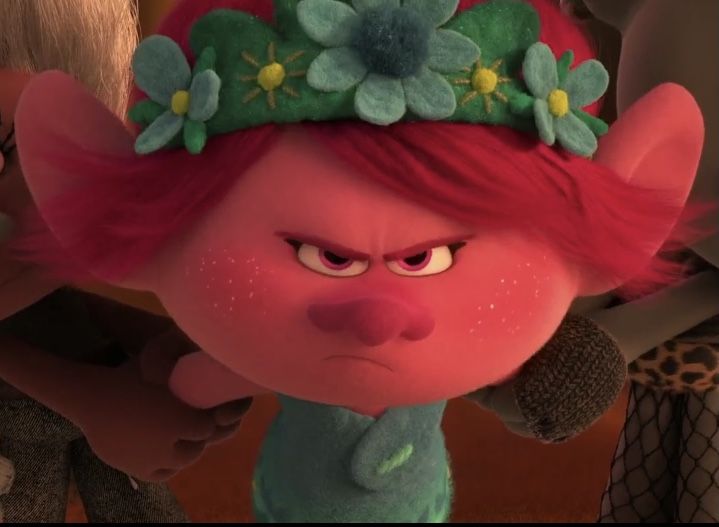 an animated character with red hair and flowers on her head is looking at the camera