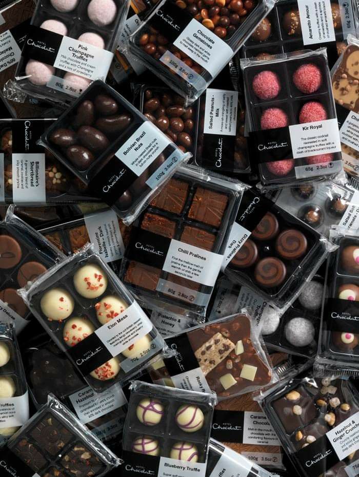 many different types of chocolates in plastic containers