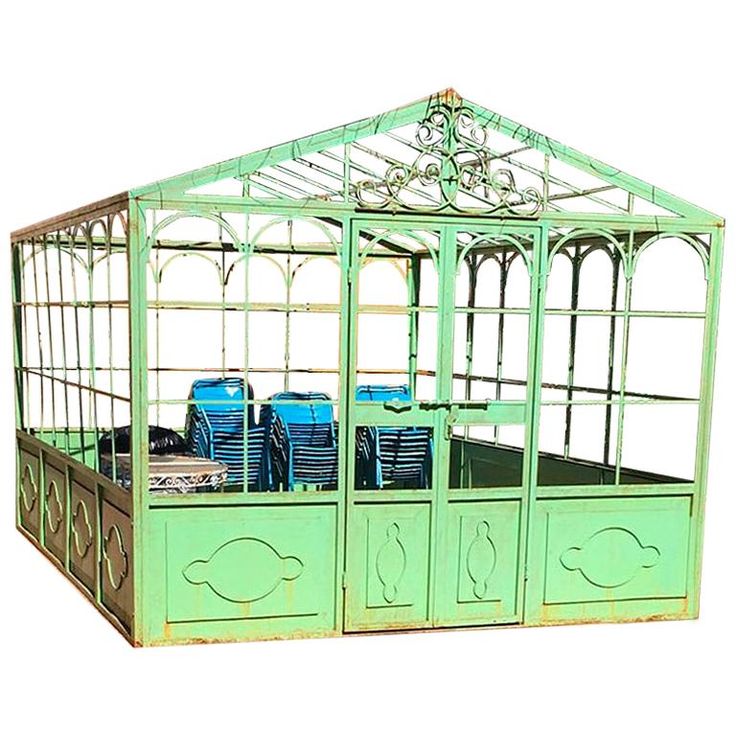 a green metal gazebo with blue chairs in the front and side panels on each side