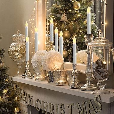 a christmas mantle with candles and ornaments on it