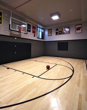 an indoor basketball court with hard wood floors