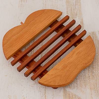 a wooden comb that is shaped like a heart