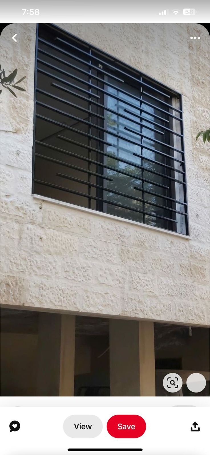 an image of a window that is on the side of a building with black shutters