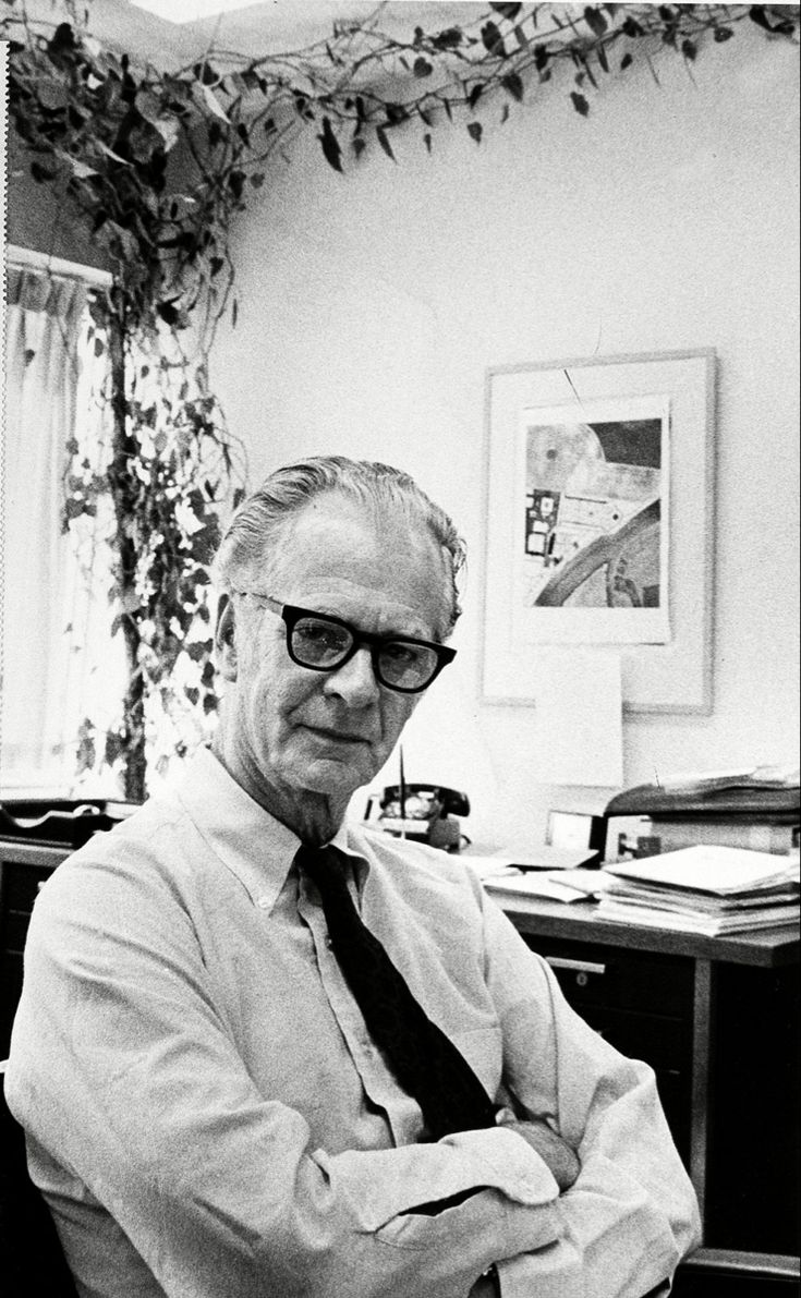 black and white photograph of an older man in his office