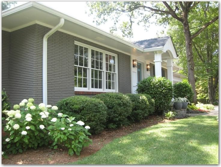 a gray house with white trim and windows