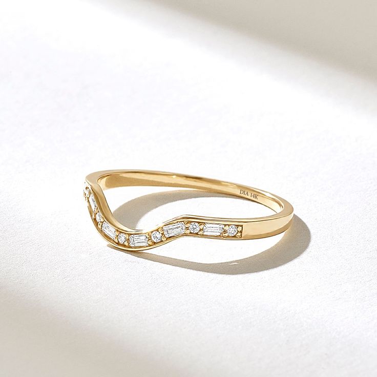 a gold ring with white stones on it