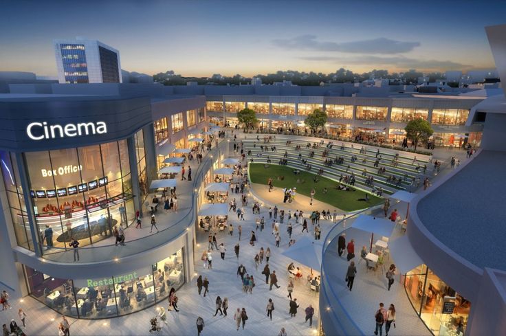 an aerial view of a shopping mall with people walking around it at dusk or dawn