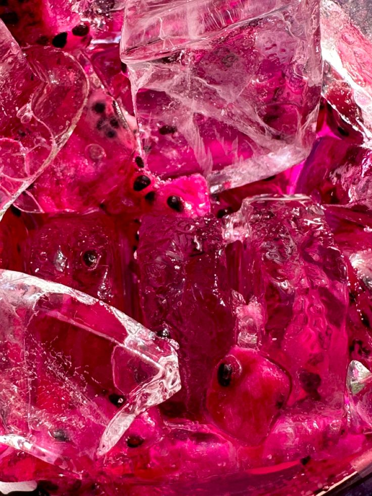 some pink ice cubes sitting on top of a table