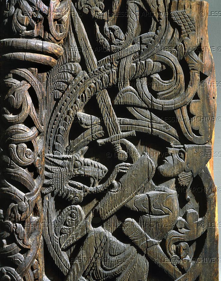 an intricate carving on the side of a wooden door, depicting people and animals in various patterns