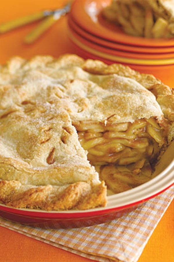 a pie on a table with plates and utensils