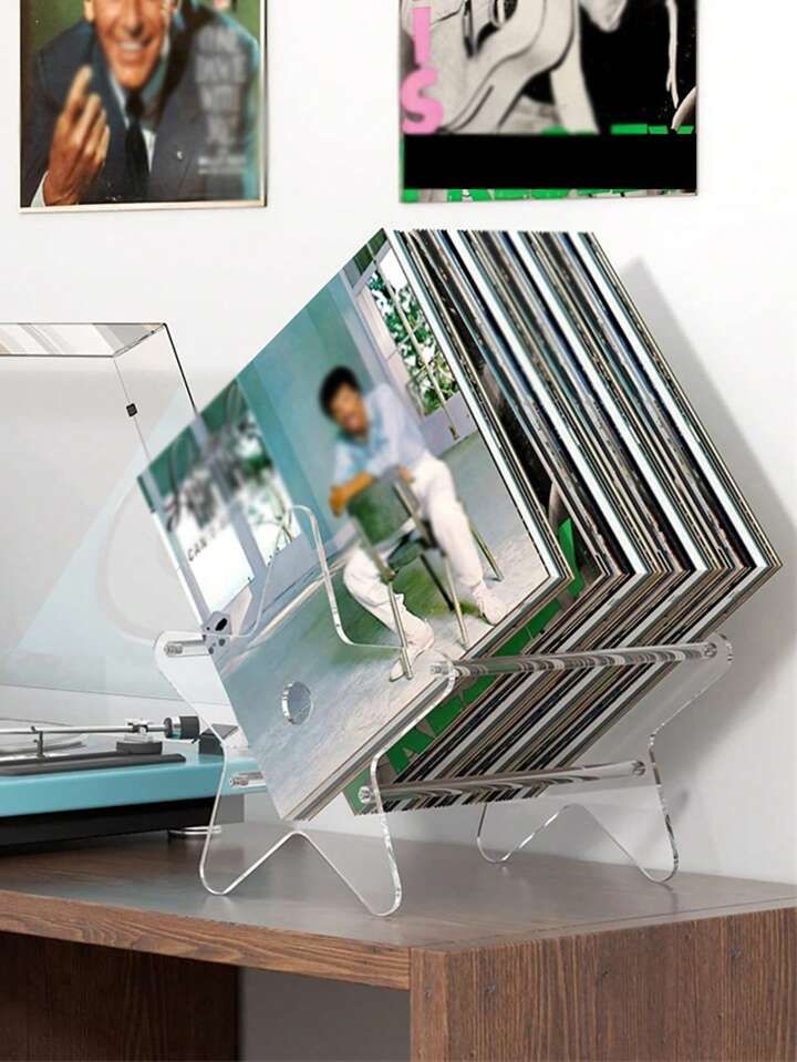 a stack of photos sitting on top of a wooden table