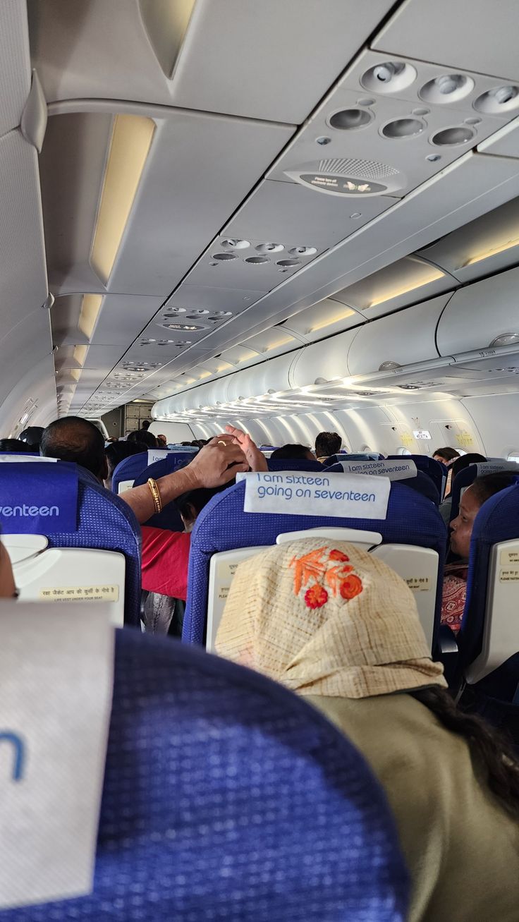 an airplane with people sitting in the seats