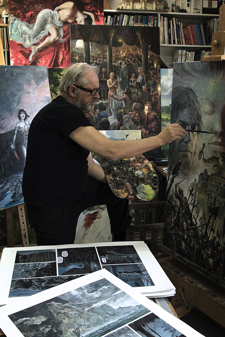 an older man is painting in his art studio