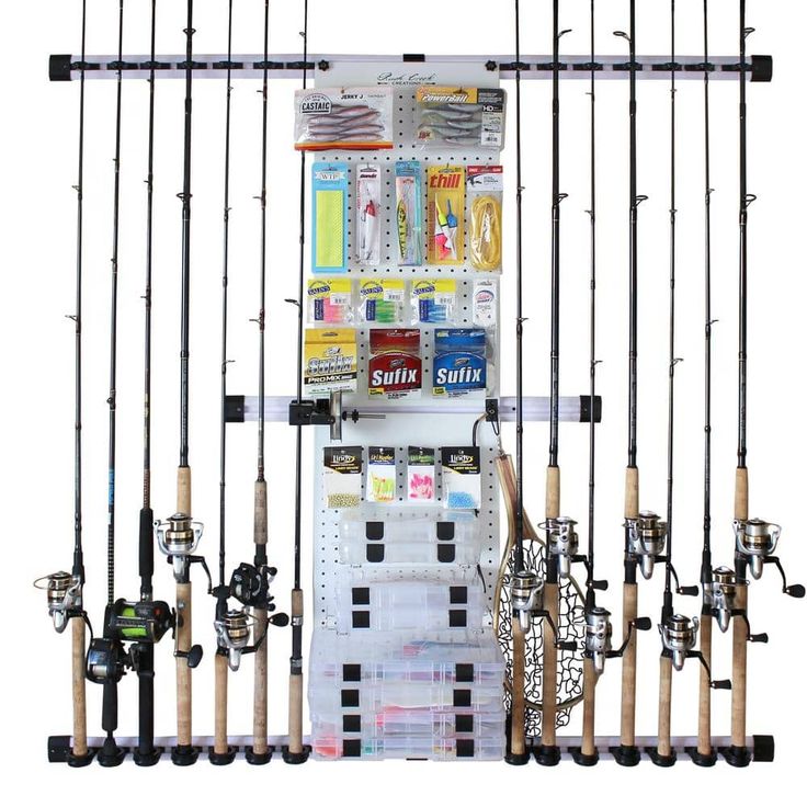 several fishing rods and reels are hanging on the wall