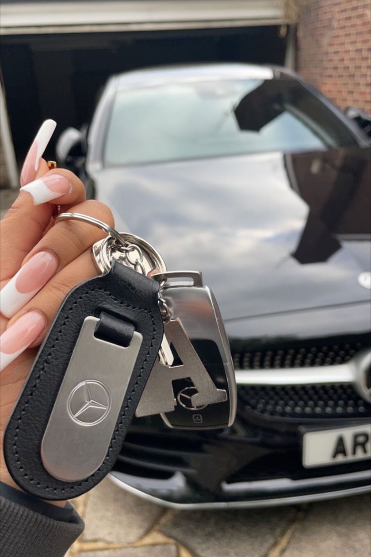 a woman holding a car key in her hand