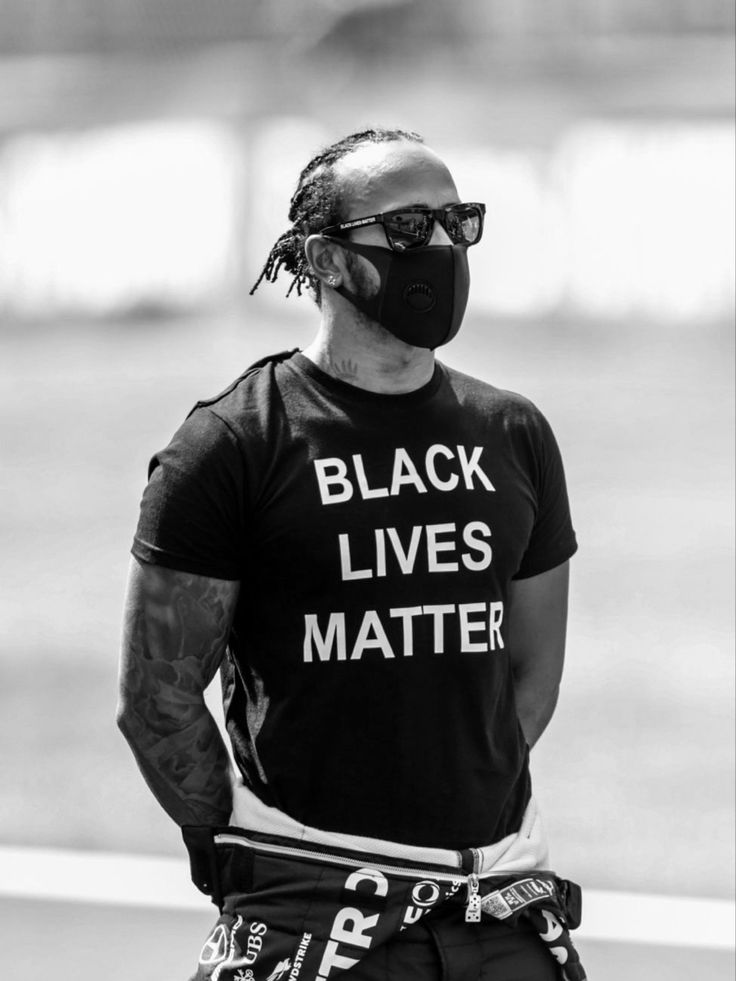 a man wearing a black lives matter t - shirt with the words black lives matter written on it