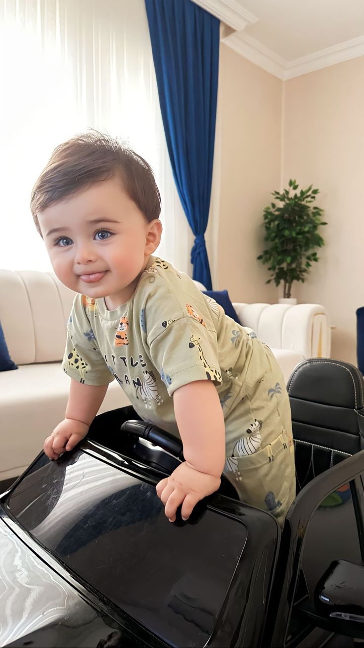 a small child standing on top of a black suitcase