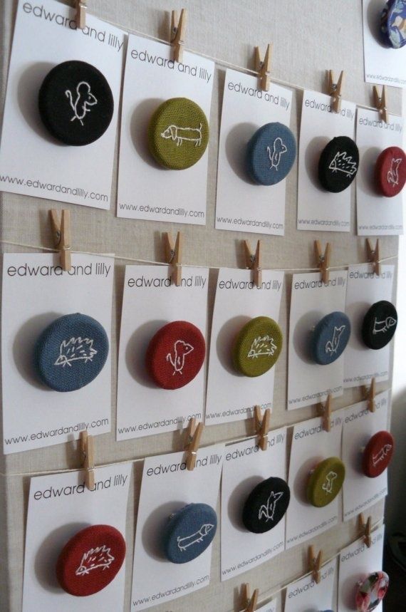 a bulletin board with magnets and clothes pins attached to the pegs on it