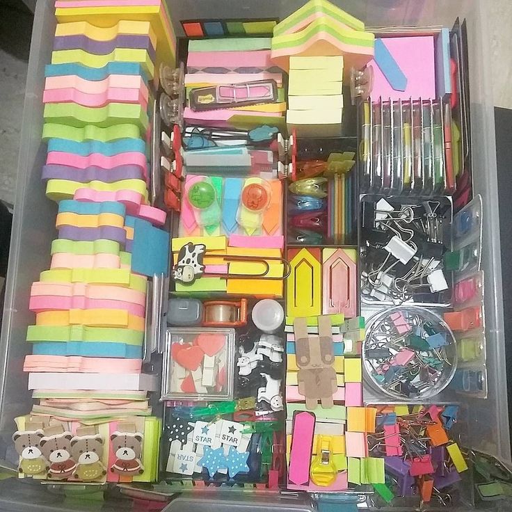 a plastic container filled with lots of different types of crafting supplies in it's storage compartment