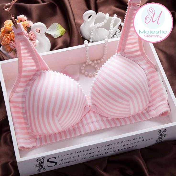 a pink and white striped bra with pearls on the side, sitting in a box