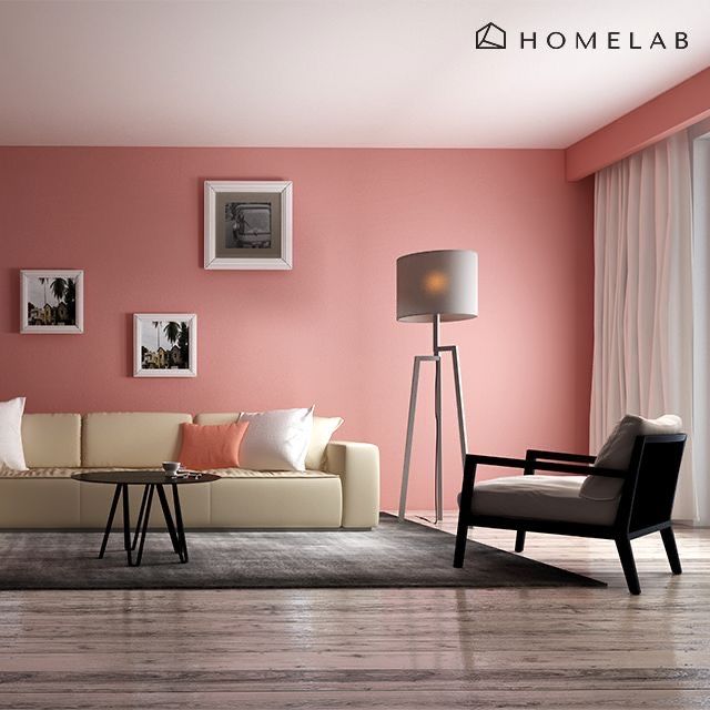 a living room with pink walls and white furniture