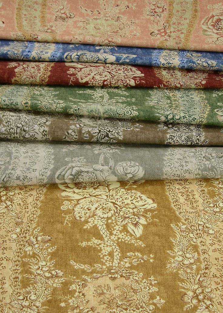 a stack of different colored fabrics on top of each other in various patterns and colors