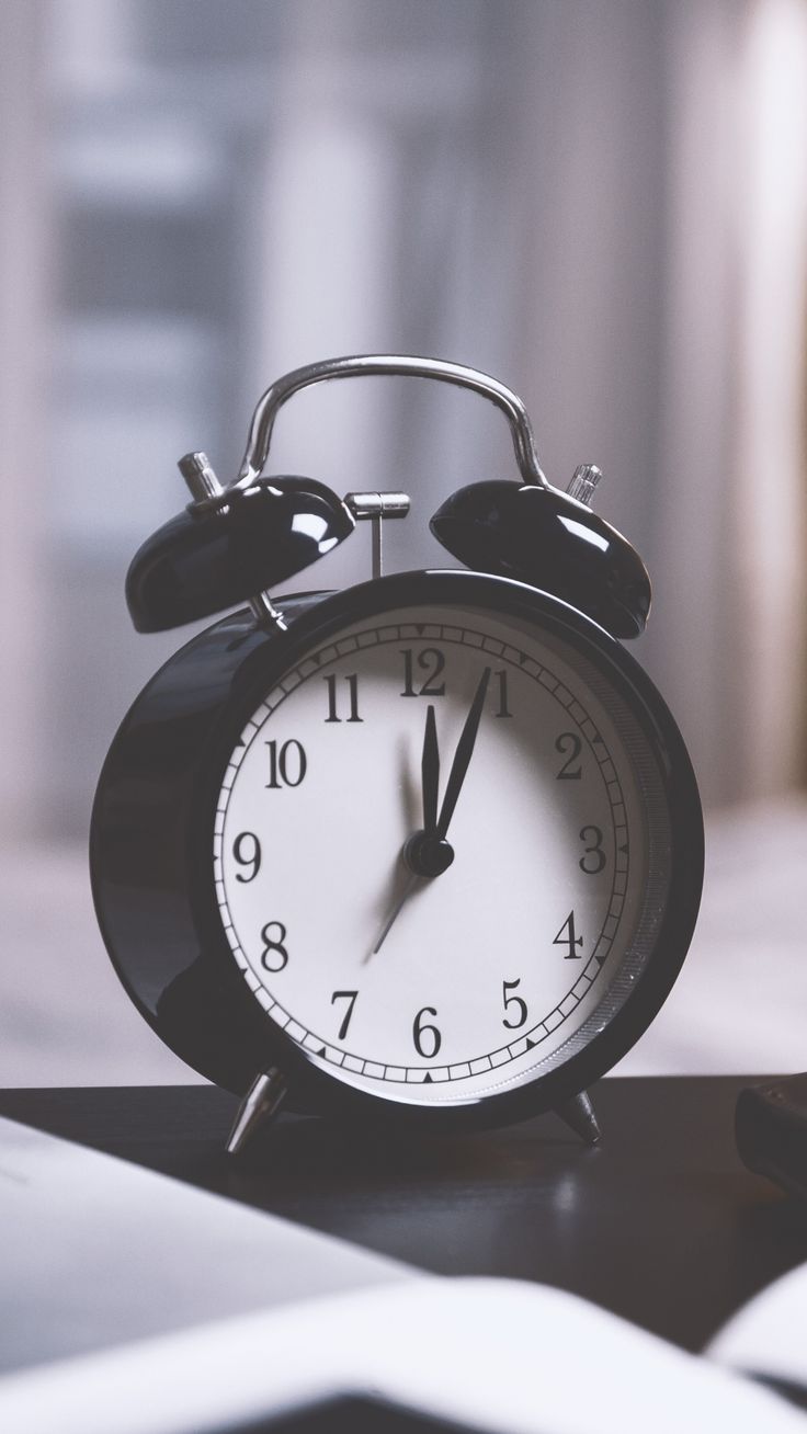 an alarm clock sitting on top of a table