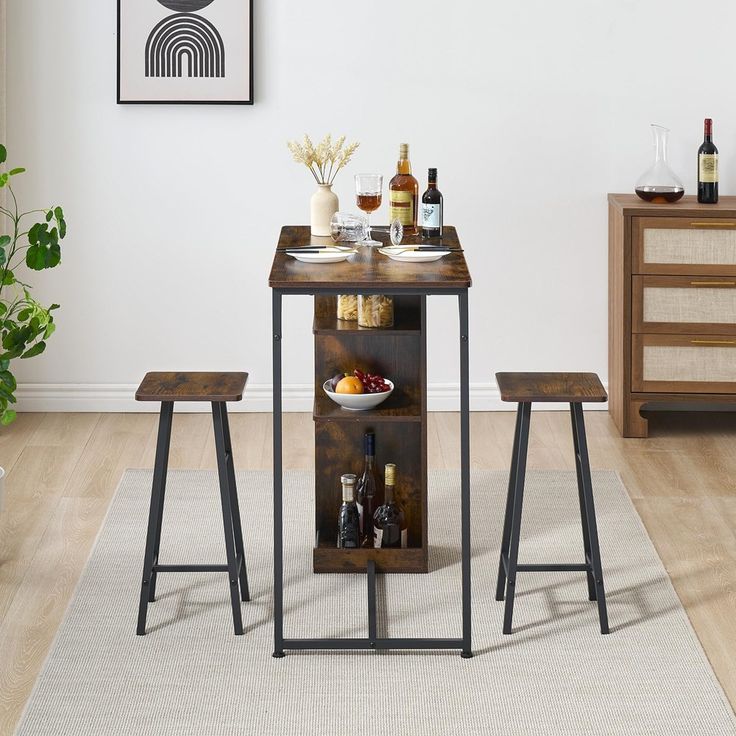 a small table with two stools in front of it and bottles on the shelf