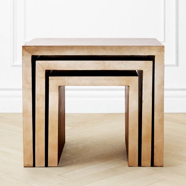 three wooden tables sitting side by side on top of a hard wood floor in front of a white wall