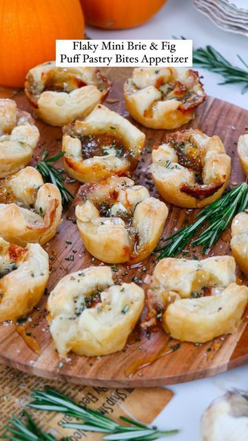 mini brie and figs puff pastry bites appetizer on a wooden platter