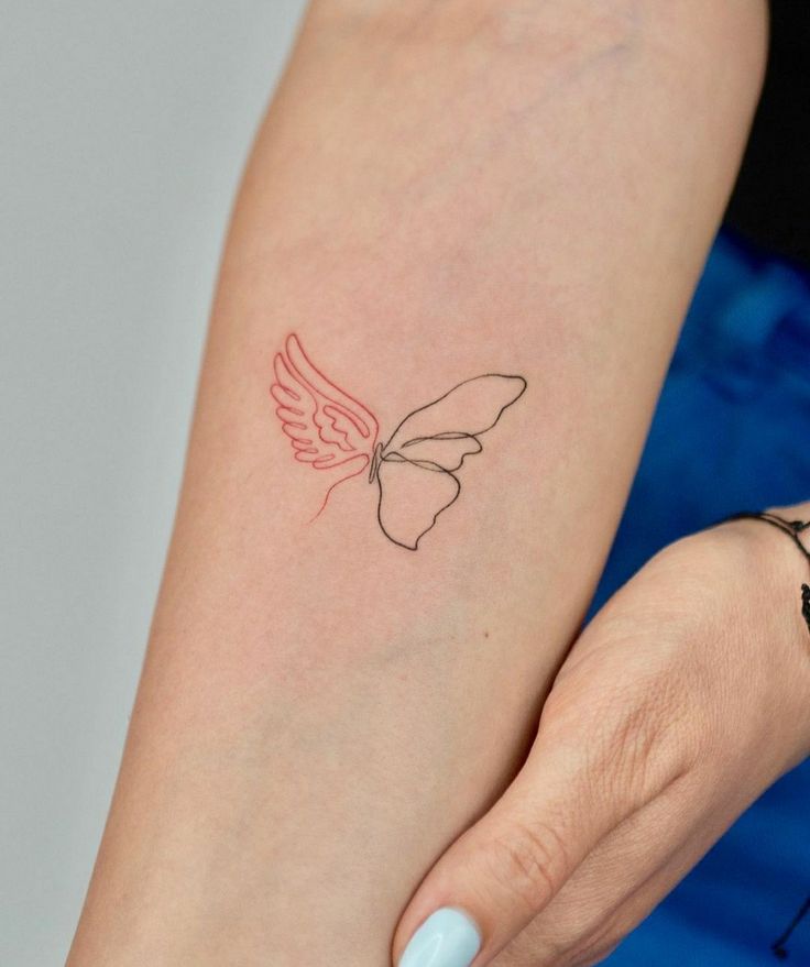 a woman's arm with a butterfly tattoo on the left side of her arm