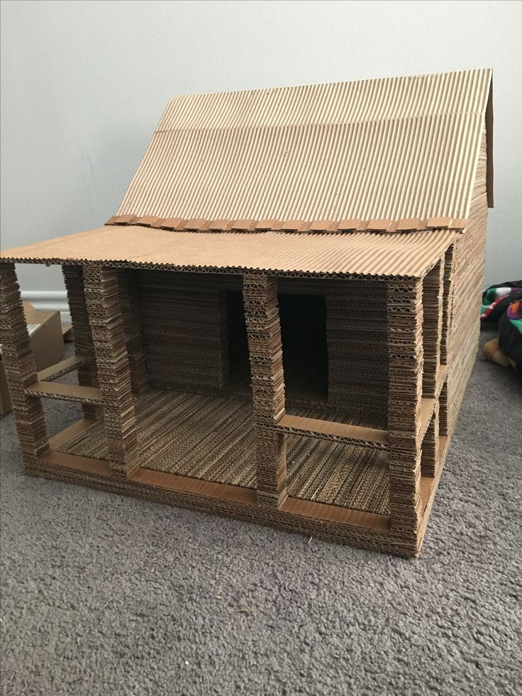 a doll house made out of cardboard sitting on the floor