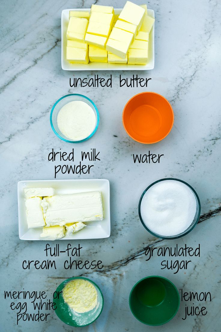 the ingredients to make cheesecakes are shown on a marble counter top, including butter, cream, and sugar