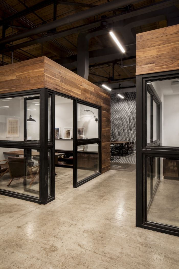 an office with glass walls and wood paneling