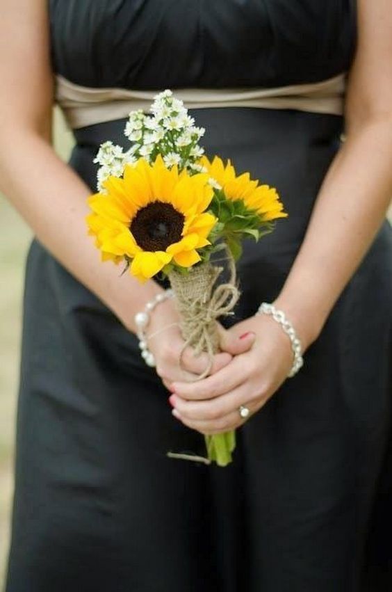 a woman holding a bouquet of sunflowers on her wedding day, with the caption pinterest 100 + ideas about sunflower bouquet