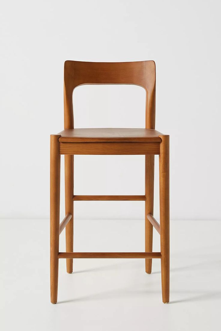 a wooden chair sitting on top of a white floor