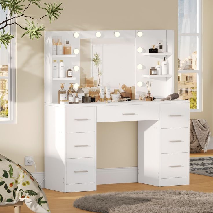 a white vanity with lights on it in front of a window and potted plant