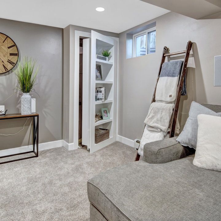 a living room filled with furniture and a large clock on the wall above it's doorway