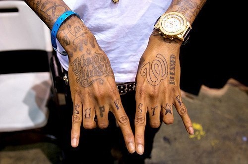 a man with many tattoos on his hands