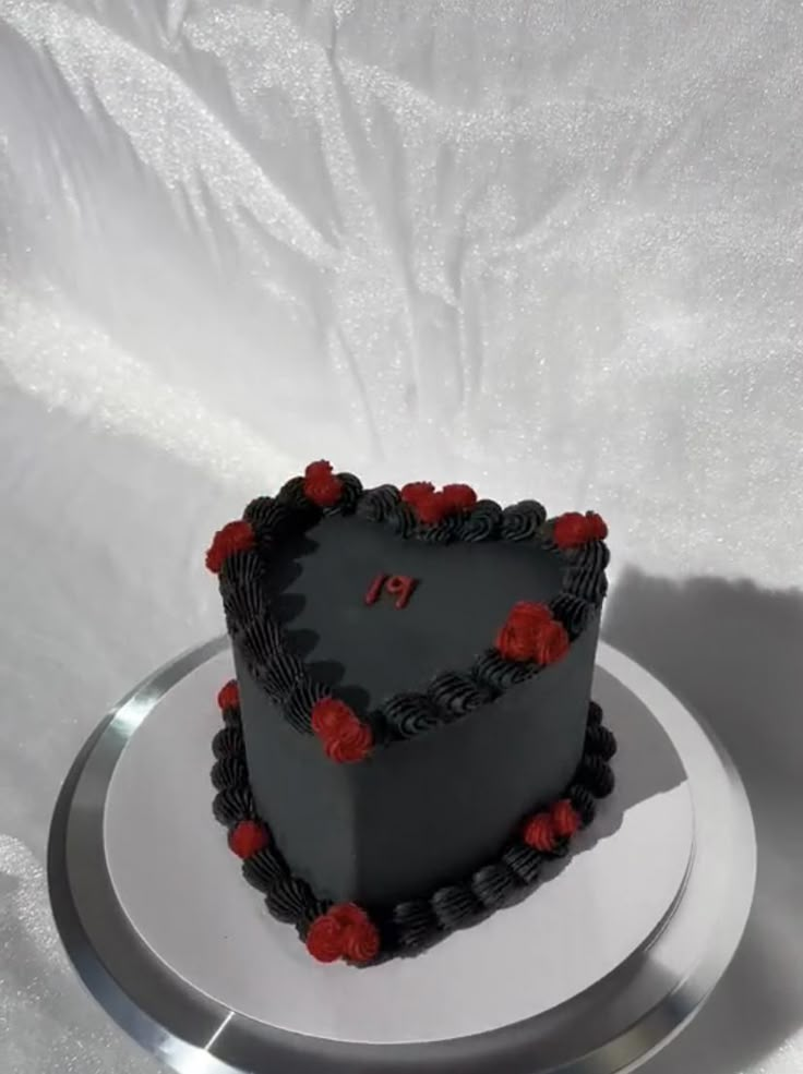 a heart shaped cake sitting on top of a white plate