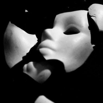 a black and white photo of two masks