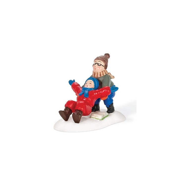 a figurine of a man sitting on top of a snowboard next to another person