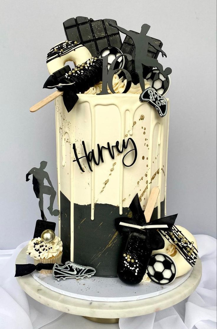 there is a cake with black and white decorations on the top, along with other items